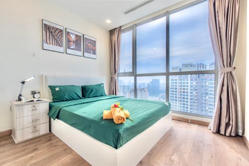 a bedroom with a bed and a large window at MOTT HAVEN APART - Vinhomes Central Park, Landmark 81 Area & Ice Rink in Ho Chi Minh City