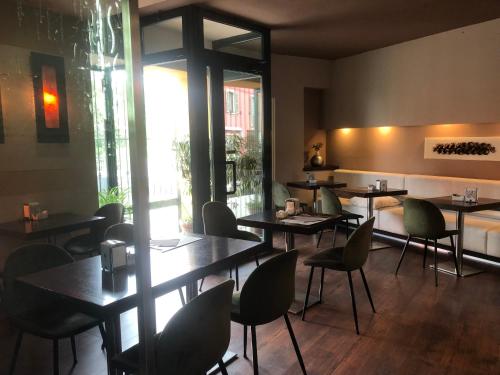 a restaurant with tables and chairs in a room at HOTEL DEL CORSO in Borgomanero