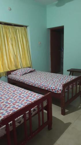 two bunk beds in a room with a table at Nandanam homestay in Varkala