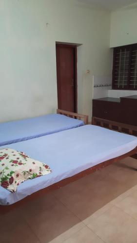 a large bed in a room with at Nandanam homestay in Varkala