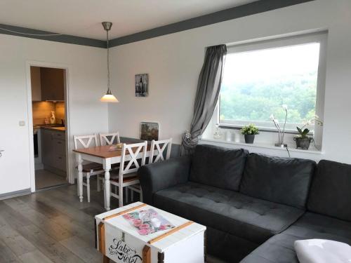 a living room with a couch and a table at Apartment Atzert in Malente