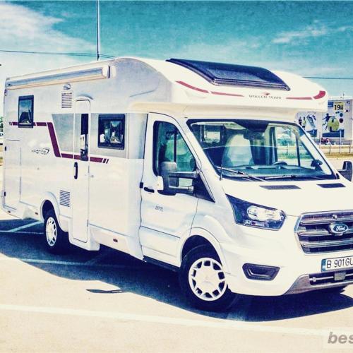 a white rv parked in a parking lot at SONIA in Otopeni