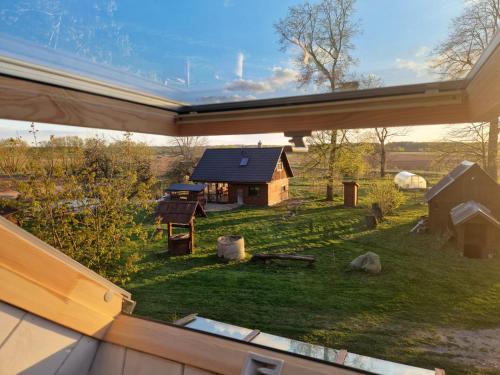 a view of a barn from the window of a house at Bajāri - Pirts - Banya in Svente