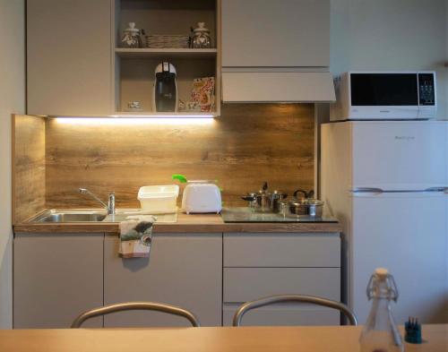 a small kitchen with a sink and a refrigerator at Appartamento OUT OF TIME in Valbrona