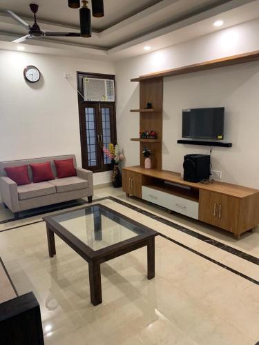 a living room with a couch and a coffee table at Nature's Blessing Rishikesh 1BHK Studio in Rishīkesh