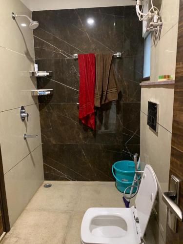 a bathroom with a toilet and a shower at Nature's Blessing Rishikesh 1BHK Studio in Rishīkesh