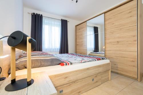 a bedroom with a bed and a mirror at Apartments Sara in Milohnići
