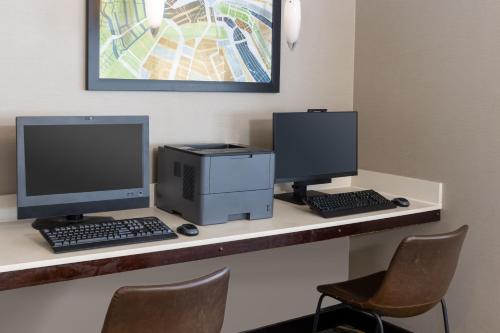 a desk with two computer monitors and a printer at Residence Inn Largo Medical Center Drive in Largo