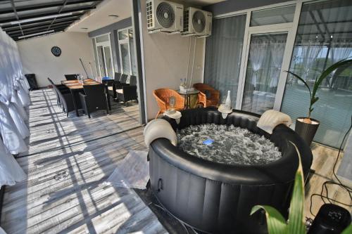 a large hot tub in the middle of a patio at Apartman Zemplinska Širava Timea in Kaluža