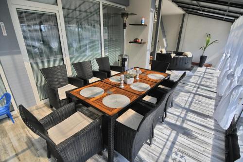 a dining table and chairs in a living room at Apartman Zemplinska Širava Timea in Kaluža