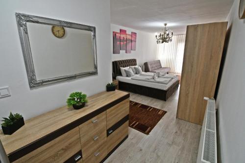 a living room with a large mirror on the wall at Apartman Zemplinska Širava Timea in Kaluža