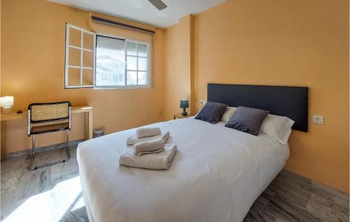 a bedroom with a large white bed with towels on it at Stunning Home In Torre De Benagalbon With Outdoor Swimming Pool in Torre de Benagalbón