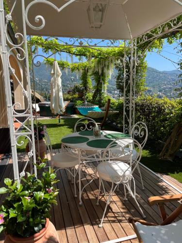 a patio with a table and chairs on a deck at Villa Mares - sea view, free garage in Rapallo
