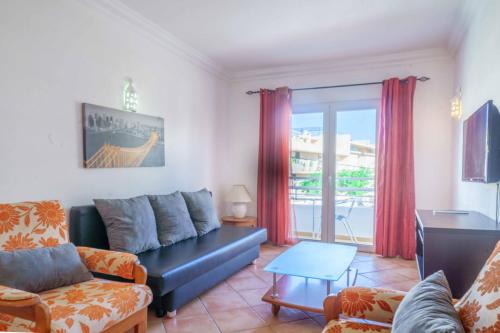 a living room with a couch and a table at Apartamentos Solar do Sol in Albufeira