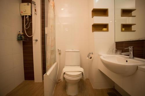 a white bathroom with a toilet and a sink at P2 Boutique in Bangkok
