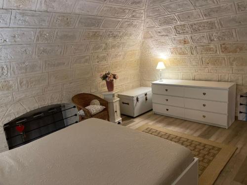a room with a bed and a dresser and a table at Casa della Luna in Bari