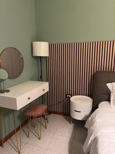 a hotel room with a bed and a desk and a sink at ApartHotel Verona Centro in Verona