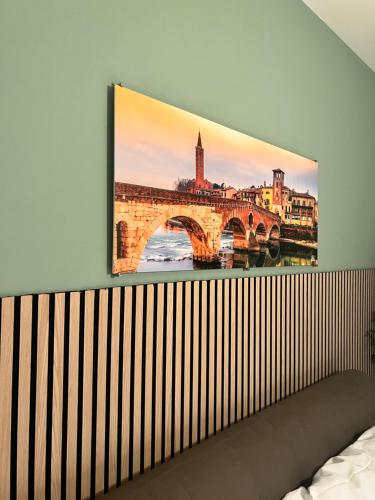 a painting of a bridge on a wall at ApartHotel Verona Centro in Verona
