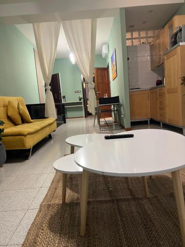 a living room with two tables and a couch at ApartHotel Verona Centro in Verona