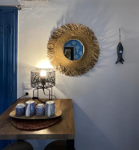 a table with a mirror and a table with candles on it at Chez Cécile Home in Mochlos