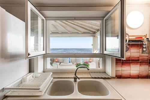 a kitchen with a sink and a window at Villa Vivimar in Siracusa