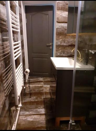 a bathroom with a sink and a door at Silene Studio in Craiova