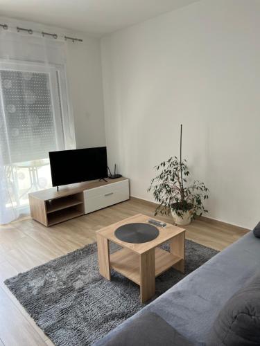 a living room with a tv and a coffee table at Apartment Sunrise with private parking in Pula