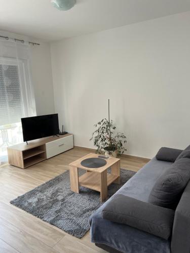 a living room with a couch and a coffee table at Apartment Sunrise with private parking in Pula