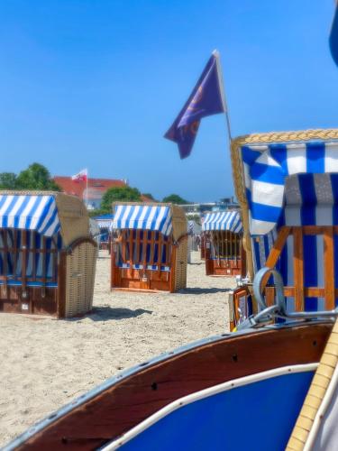 a group of beach loungers and chairs on the beach at Ferienwohnung Nelia in Lübeck