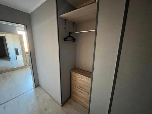 a walk in closet with a mirror in a room at RONY apartment in Liepāja