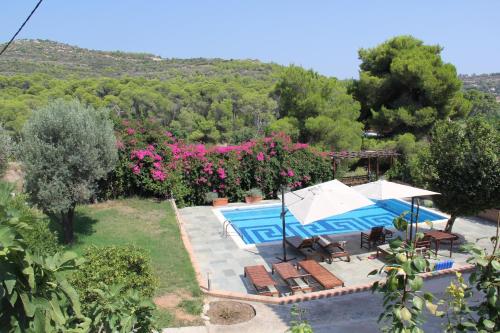 an external view of a villa with a swimming pool at Villa Conte in Panayías