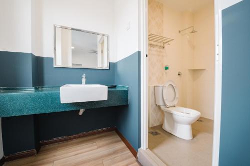 a bathroom with a sink and a toilet at The Concept Hotel KL - Batu Caves in Batu Caves