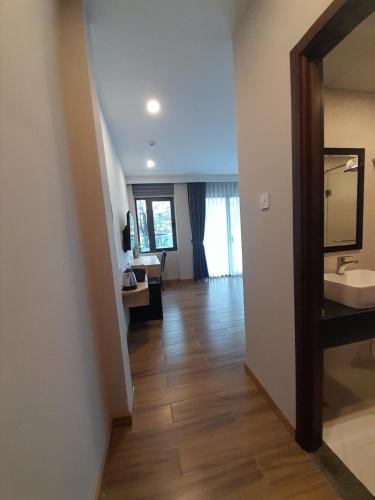 a room with a hallway with a sink and a mirror at Happy Home in Nha Trang