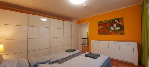 a bedroom with two beds and a painting on the wall at Stilvolles Haus 124 qm in Balingen