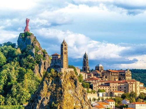 a city on top of a mountain with a town at Appartement Foch in Le Puy en Velay