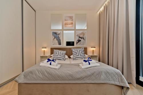 Кровать или кровати в номере BlueApart Apartamenty Portowa