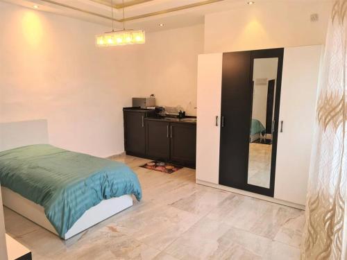 a bedroom with a bed and a mirror at Khalda Rooftop Apt. in Amman
