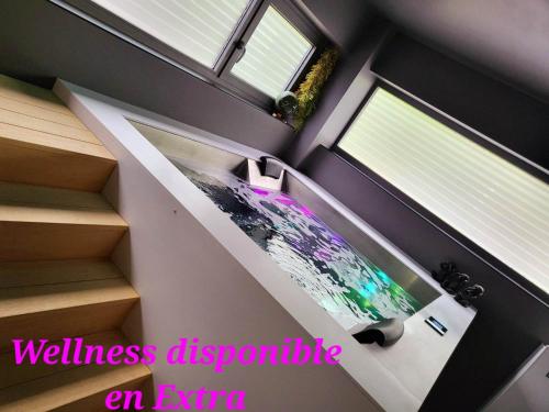 a room with stairs with a television in it at Table et chambre particulière in Mons
