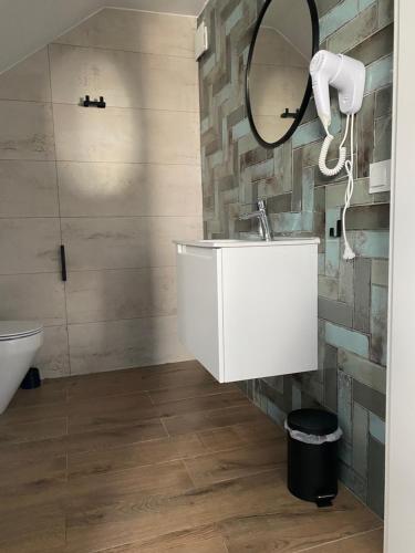 ein Bad mit einem Waschbecken und einem Spiegel in der Unterkunft PORTKNAUBER in Rowy