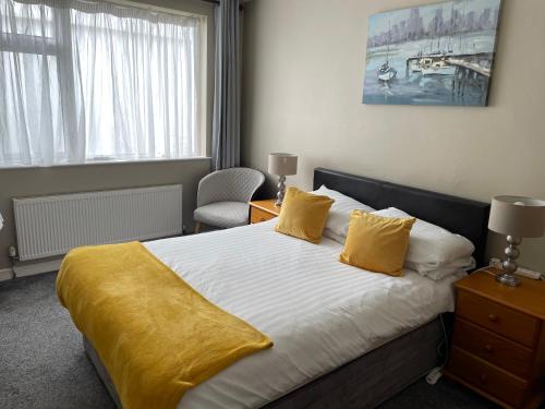 a bedroom with a bed with a yellow blanket on it at Fountain House B&B in Macroom