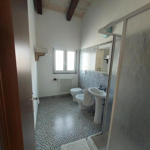 a bathroom with two toilets and a sink at Residence Ca Giuliocesare in Castiglione di Ravenna