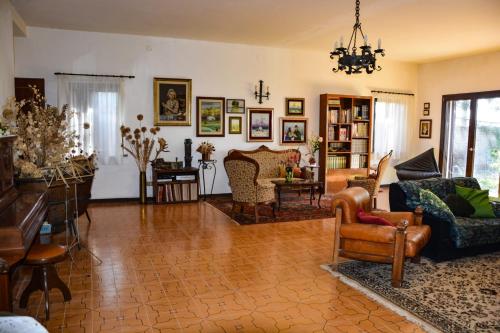 a living room with couches and chairs at La Casa di Cesarina in Celle sul Rigo