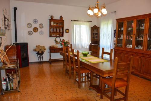 a dining room with a wooden table and chairs at La Casa di Cesarina in Celle sul Rigo