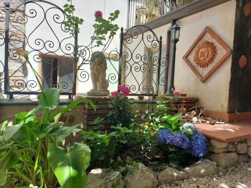 a garden with a bench in front of a gate at Giardino Del Sole in Taormina