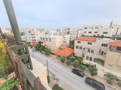 a view of a city street with buildings at Khalda Rooftop Apt. in Amman