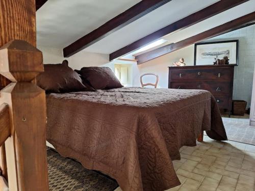 a bedroom with a large bed and a dresser at Casa di Pilou - Maison et jardin près de la mer - Corbara in Corbara