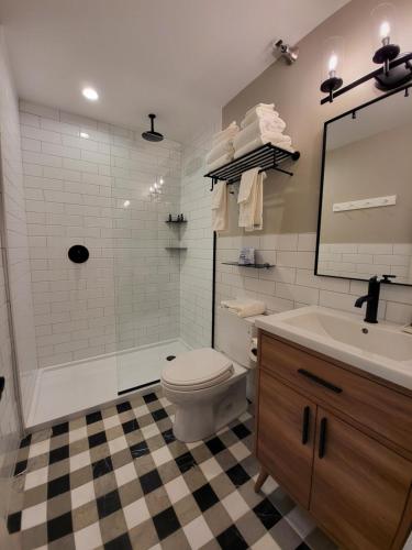 a bathroom with a tub and a toilet and a sink at The Stowe Village Inn in Stowe