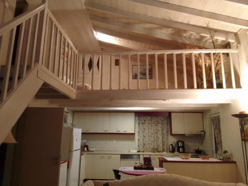 a small kitchen with a staircase in a house at Eloise in Agriovótanon