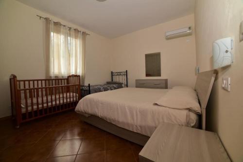 a small bedroom with a bed and a crib at Casa vacanze il Pastore Tedesco in Portoferraio