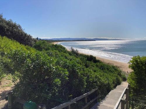 a path to the beach with the ocean in the background at Selenas @ Culburra Beach in Culburra Beach